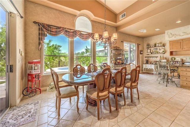 27 Via Paradiso St, Henderson, NV 89011 - dining area featuring light tile patterned floors, a chandelier, plenty of natural light, lofted ceiling, and baseboards