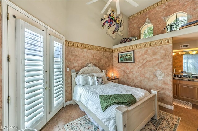 27 Via Paradiso St, Henderson, NV 89011 - bedroom featuring light tile patterned floors, multiple windows, a high ceiling, and baseboards