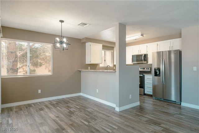 6873 Tamarus St Unit 201, Las Vegas, NV 89119 - kitchen featuring appliances with stainless steel finishes, dark wood finished floors, white cabinetry, and a sink