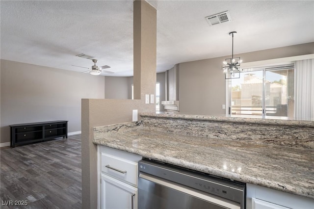 6873 Tamarus St Unit 201, Las Vegas, NV 89119 - kitchen with stainless steel dishwasher, plenty of natural light, white cabinetry, a textured ceiling, and dark wood finished floors