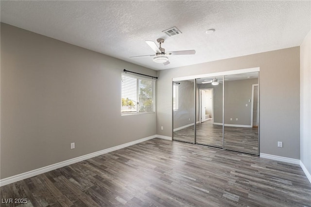 6873 Tamarus St Unit 201, Las Vegas, NV 89119 - unfurnished bedroom with wood finished floors, a textured ceiling, baseboards, a closet, and ceiling fan