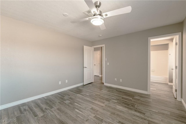 6873 Tamarus St Unit 201, Las Vegas, NV 89119 - unfurnished bedroom with wood finished floors, baseboards, and ceiling fan