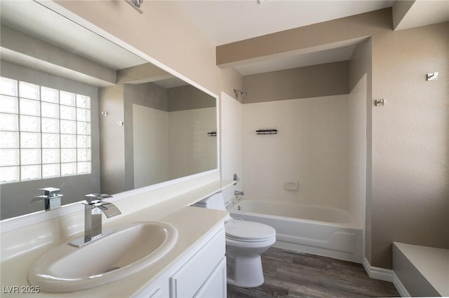 6873 Tamarus St Unit 201, Las Vegas, NV 89119 - bathroom with vanity, toilet, wood finished floors, and shower / bathtub combination