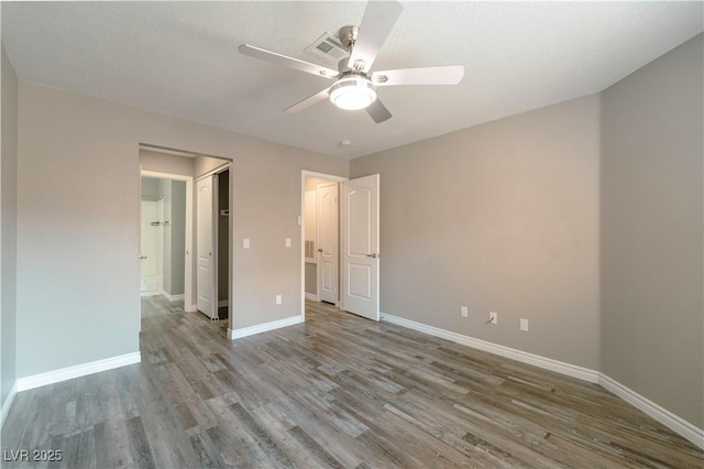 6873 Tamarus St Unit 201, Las Vegas, NV 89119 - unfurnished bedroom featuring wood finished floors, baseboards, and ceiling fan