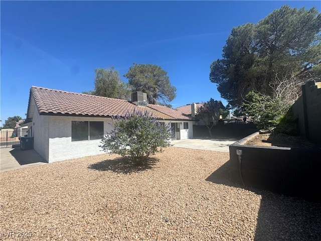 3920 Aspencrest Dr, Las Vegas, NV 89108 - rear view of house with a tiled roof, stucco siding, a patio, and central AC unit