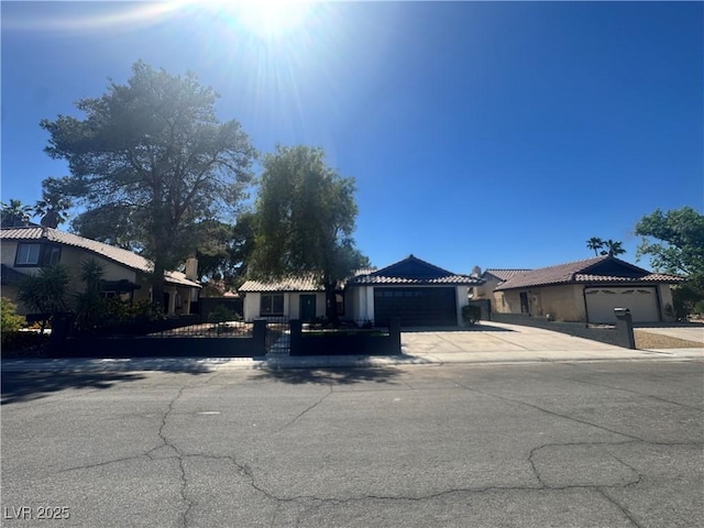 3920 Aspencrest Dr, Las Vegas, NV 89108 - ranch-style house featuring an attached garage, concrete driveway, a tile roof, and a gate