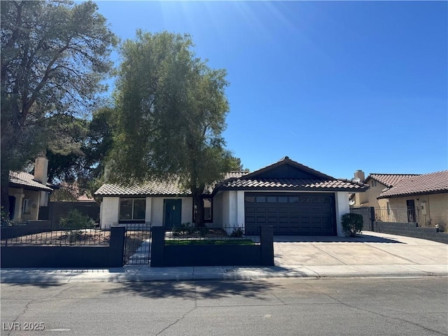 3920 Aspencrest Dr, Las Vegas, NV 89108 - view of front of property featuring a gate, a garage, driveway, a tile roof, and stucco siding