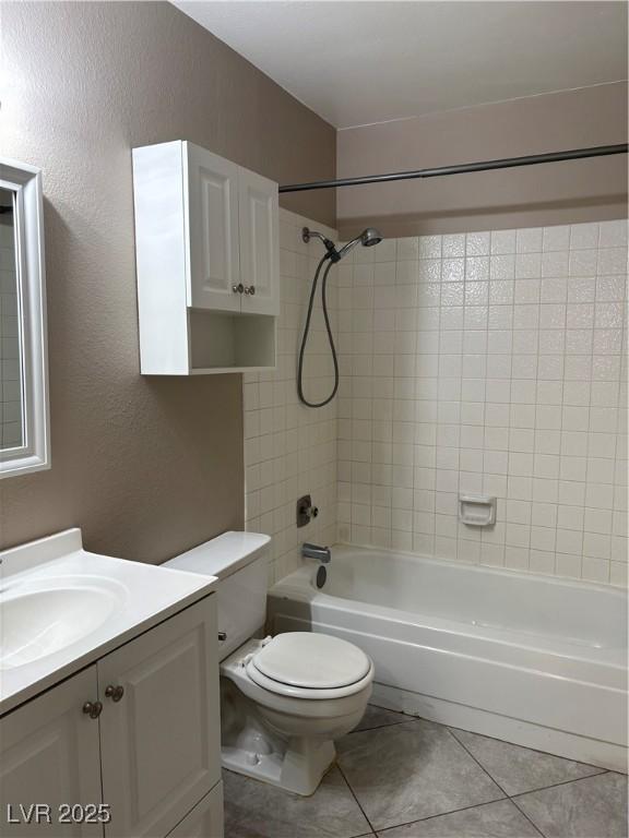 461 N Lamb Blvd Unit H, Las Vegas, NV 89110 - bathroom featuring tile patterned flooring, toilet, vanity, bathtub / shower combination, and a textured wall
