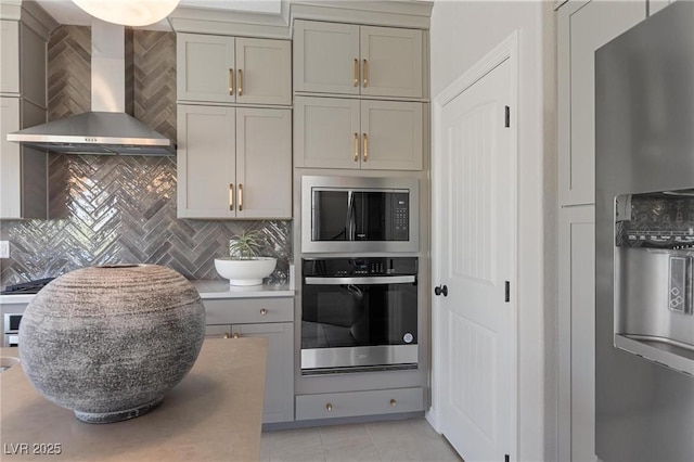 7983 Texas Hills St, Las Vegas, NV 89113 - kitchen with appliances with stainless steel finishes, wall chimney range hood, backsplash, and light tile patterned floors