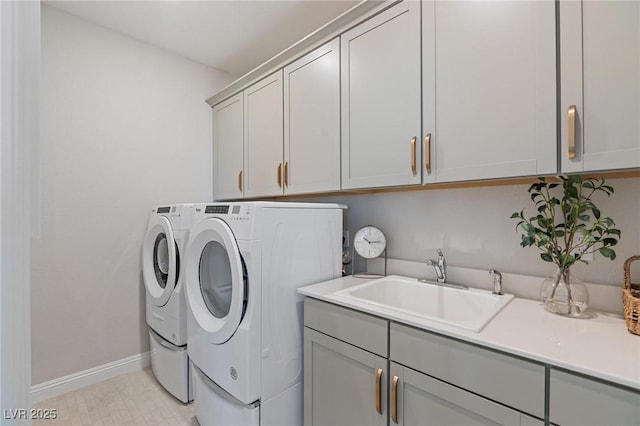 7983 Texas Hills St, Las Vegas, NV 89113 - laundry room with washing machine and clothes dryer, cabinet space, and baseboards