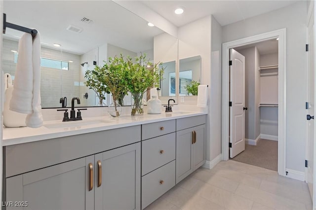 7983 Texas Hills St, Las Vegas, NV 89113 - bathroom with double vanity, a shower stall, baseboards, a spacious closet, and recessed lighting