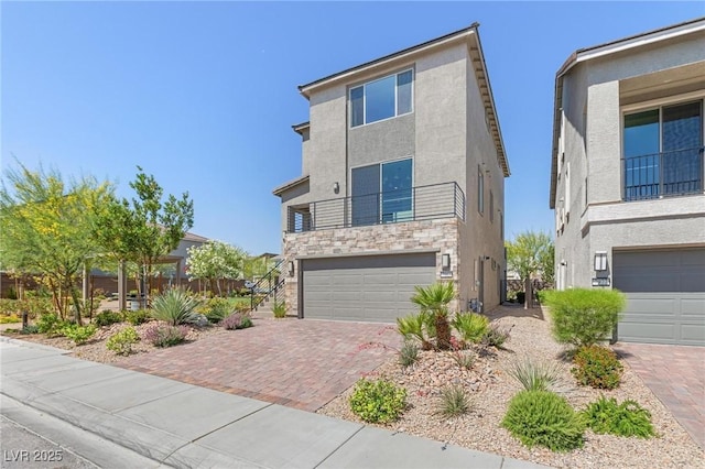 7983 Texas Hills St, Las Vegas, NV 89113 - view of front of house featuring stucco siding, stone siding, an attached garage, and decorative driveway