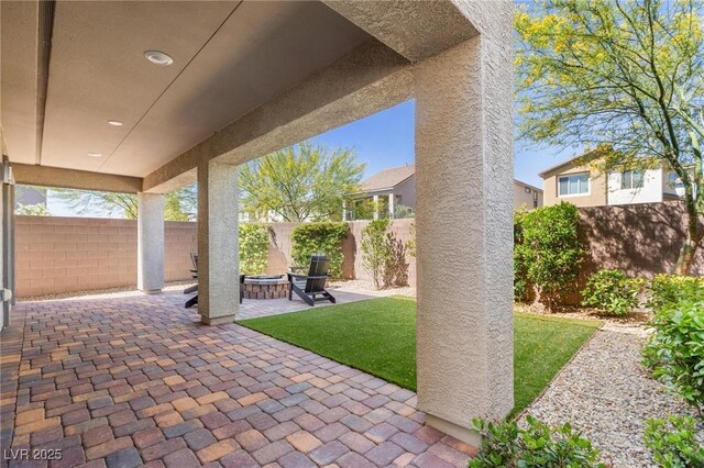 7983 Texas Hills St, Las Vegas, NV 89113 - fenced backyard featuring a patio area and an outdoor fire pit