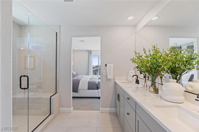 7983 Texas Hills St, Las Vegas, NV 89113 - bathroom with ensuite bathroom, double vanity, baseboards, a shower stall, and tile patterned flooring