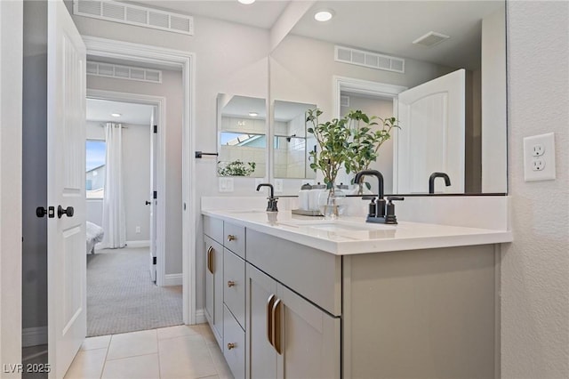 7983 Texas Hills St, Las Vegas, NV 89113 - ensuite bathroom featuring double vanity, baseboards, tile patterned flooring, and healthy amount of natural light