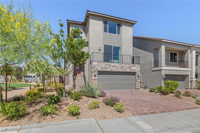 7983 Texas Hills St, Las Vegas, NV 89113 - view of front of property with a garage, stucco siding, decorative driveway, and stone siding