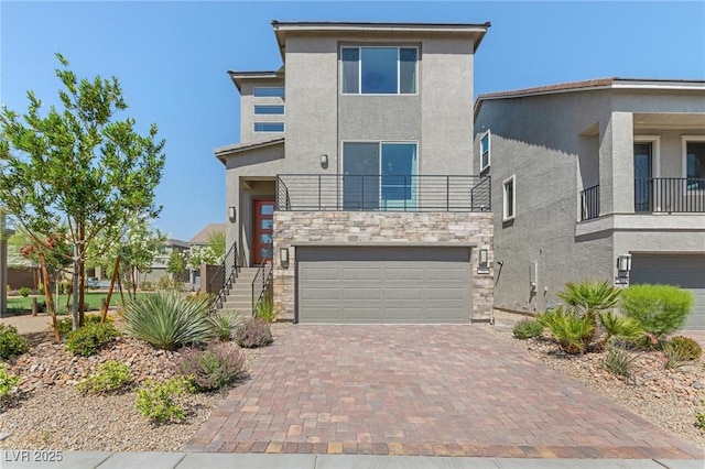 7983 Texas Hills St, Las Vegas, NV 89113 - view of front facade featuring an attached garage, stucco siding, stone siding, decorative driveway, and a balcony