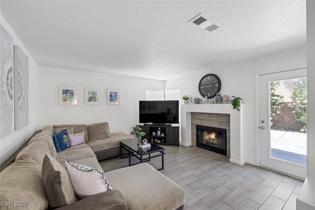 9428 Sierra Summit Ave, Las Vegas, NV 89134 - living area featuring healthy amount of natural light and a tile fireplace