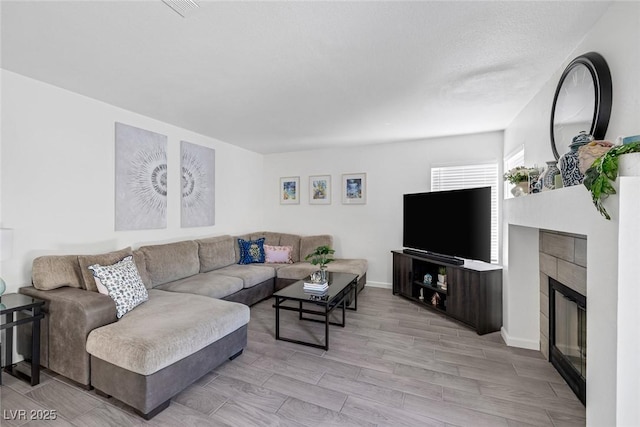 9428 Sierra Summit Ave, Las Vegas, NV 89134 - living room featuring a fireplace, light wood-type flooring, and baseboards
