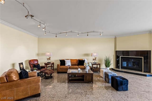 2777 Paradise Rd Unit 2302, Las Vegas, NV 89109 - living room featuring crown molding, rail lighting, granite floors, and a tiled fireplace