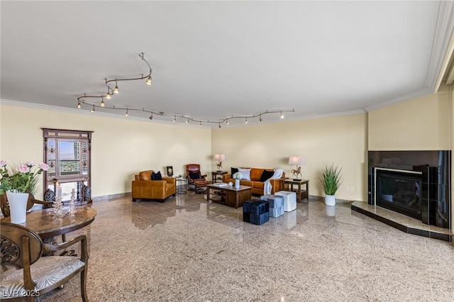 2777 Paradise Rd Unit 2302, Las Vegas, NV 89109 - living room with ornamental molding, speckle patterned floor, a glass covered fireplace, and rail lighting