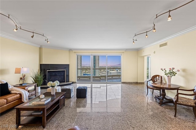 2777 Paradise Rd Unit 2302, Las Vegas, NV 89109 - living area featuring crown molding, track lighting, granite tiled floors, and a glass covered fireplace