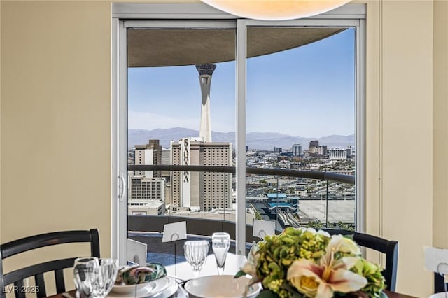 2777 Paradise Rd Unit 2302, Las Vegas, NV 89109 - dining area with a city view, a mountain view, and expansive windows