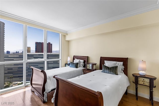 2777 Paradise Rd Unit 2302, Las Vegas, NV 89109 - bedroom with wood finished floors, ornamental molding, and a city view
