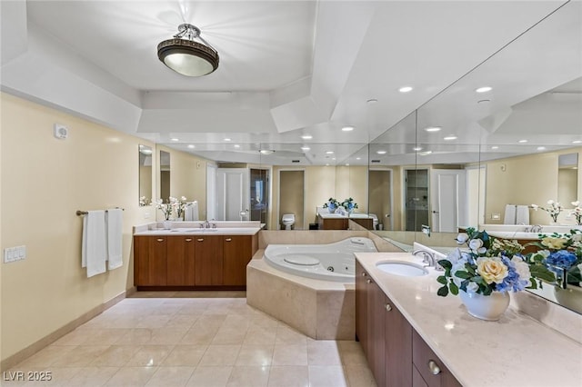 2777 Paradise Rd Unit 2302, Las Vegas, NV 89109 - full bath featuring a whirlpool tub, two vanities, tile patterned flooring, and recessed lighting