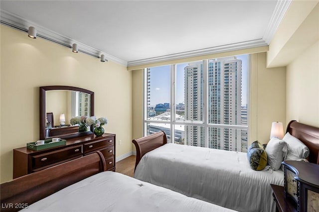 2777 Paradise Rd Unit 2302, Las Vegas, NV 89109 - bedroom featuring crown molding, multiple windows, wood finished floors, and a city view