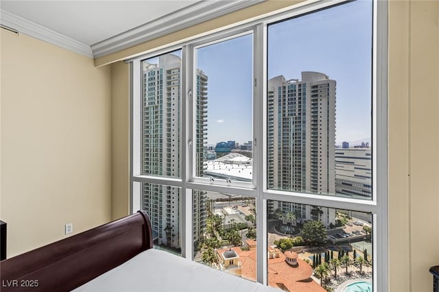 2777 Paradise Rd Unit 2302, Las Vegas, NV 89109 - bedroom with a city view, crown molding, and multiple windows
