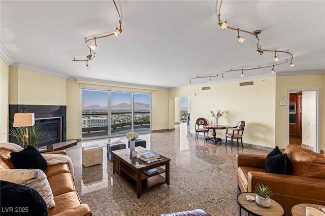 2777 Paradise Rd Unit 2302, Las Vegas, NV 89109 - living area with track lighting, crown molding, granite floors, and a fireplace