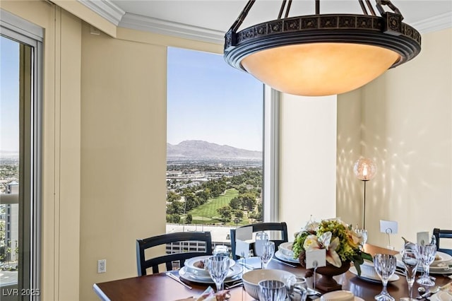 2777 Paradise Rd Unit 2302, Las Vegas, NV 89109 - dining room featuring healthy amount of natural light, a mountain view, and crown molding