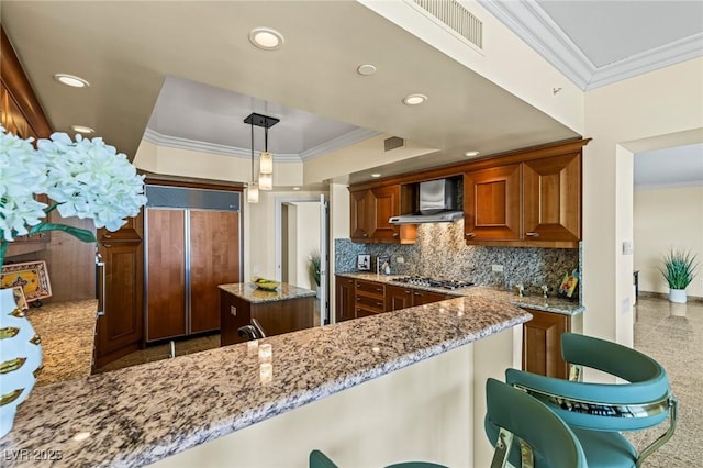2777 Paradise Rd Unit 2302, Las Vegas, NV 89109 - kitchen featuring wall chimney range hood, paneled built in refrigerator, ornamental molding, stainless steel gas cooktop, and light stone counters