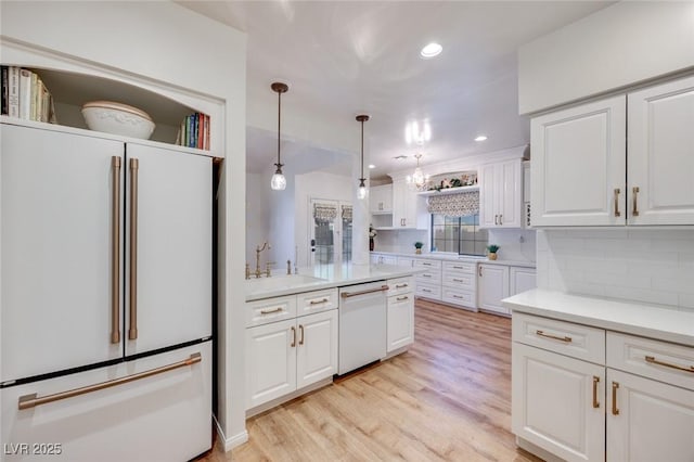 1953 Moyer Dr, Henderson, NV 89074 - kitchen featuring white appliances, white cabinets, light countertops, backsplash, and light wood-style flooring
