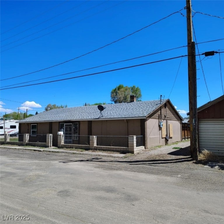 2051 N St, Ely, NV 89301 - single story home featuring a shingled roof and a chimney