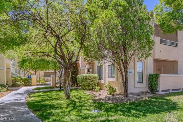 4843 S Torrey Pines Dr Unit 101, Las Vegas, NV 89103 - view of front of home featuring stucco siding and a front lawn