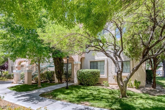 4843 S Torrey Pines Dr Unit 101, Las Vegas, NV 89103 - view of front of property with stucco siding, a front yard, and stairway
