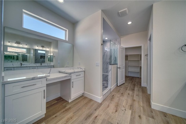 4861 Ridgewood, Pahrump, NV 89061 - full bath with a marble finish shower, vanity, wood finished floors, baseboards, and recessed lighting