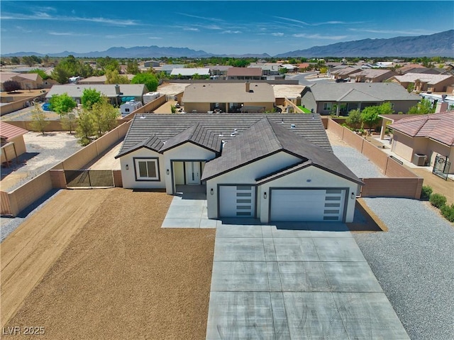 4861 Ridgewood, Pahrump, NV 89061 - view of front of home with a garage, a residential view, a mountain view, and driveway