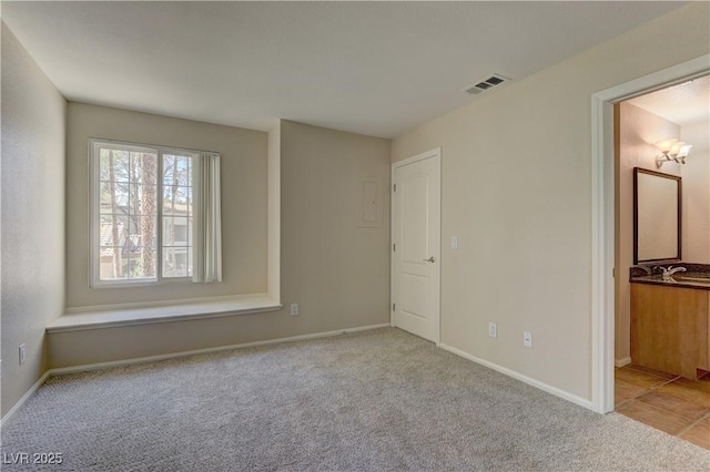 3145 E Flamingo Rd Unit 2080, Las Vegas, NV 89121 - unfurnished bedroom featuring carpet floors, baseboards, and connected bathroom
