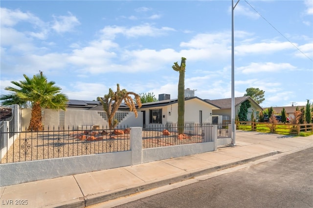 4301 Fortune Ave, Las Vegas, NV 89107 - view of front of house featuring a fenced front yard, solar panels, and stucco siding