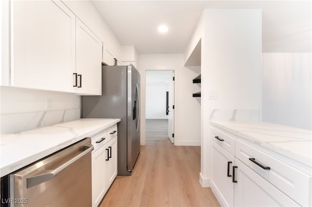 4301 Fortune Ave, Las Vegas, NV 89107 - kitchen with stainless steel appliances, white cabinetry, light wood-type flooring, light stone countertops, and recessed lighting