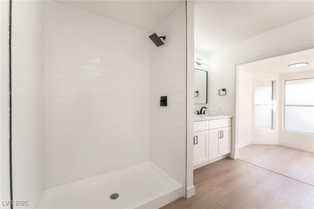 4301 Fortune Ave, Las Vegas, NV 89107 - full bath with vanity, wood finished floors, and a tile shower