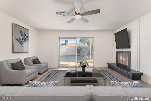 4301 Fortune Ave, Las Vegas, NV 89107 - living room featuring ceiling fan and a tiled fireplace