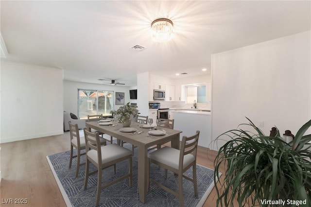 4301 Fortune Ave, Las Vegas, NV 89107 - dining space with a chandelier, light wood-style floors, and ceiling fan