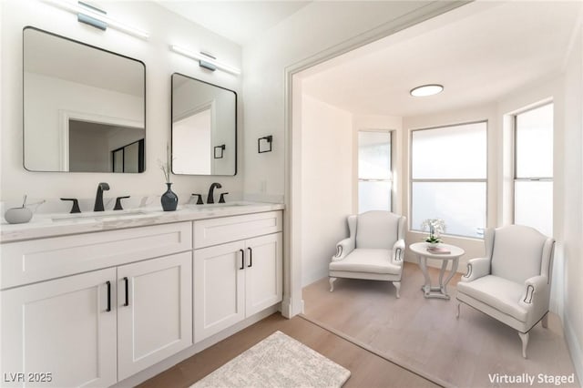 4301 Fortune Ave, Las Vegas, NV 89107 - bathroom featuring double vanity, wood finished floors, and baseboards