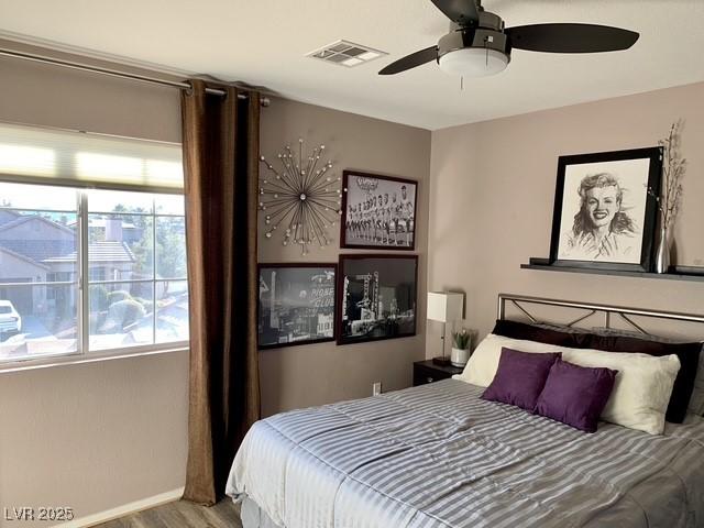 9485 Supernova Ct, Las Vegas, NV 89123 - bedroom with wood finished floors and a ceiling fan