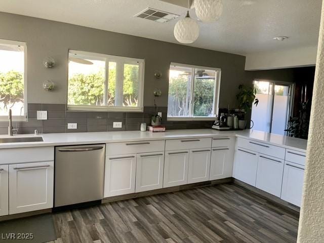 9485 Supernova Ct, Las Vegas, NV 89123 - kitchen featuring dishwasher, light countertops, dark wood-type flooring, and white cabinets
