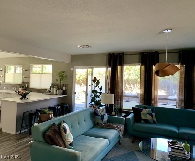 9485 Supernova Ct, Las Vegas, NV 89123 - living area featuring wood finished floors and a textured ceiling